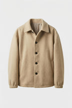 Beige jacket with black buttons on a light gray background