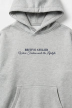 Gray hoodie with 'BRITIVO ATELIER' text on a white background